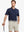 Model wearing Modern Texture Stylish Polo in NAVY, front half-body view holding golf club.