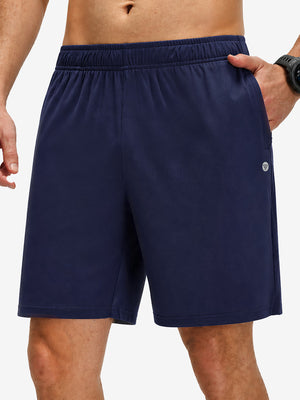 Front lower body shot of model wearing navy breathable running shorts with 4 zipper pockets