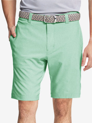 Front view of youth wearing mint green Heather Performance Golf Shorts, showing fit and style