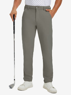 Lightweight moisture wicking dress pants in dark khaki, front lower-body with model leaning on golf club.
