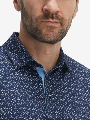 Front view from nose to chest of model wearing the dark blue golf club 4 way stretch print collared polo shirt, showcasing the upper fit
