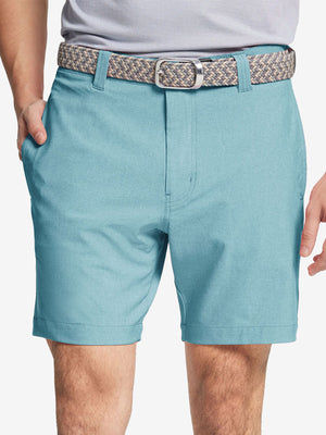 Front view of youth wearing blue light Heather Performance Golf Shorts, showing fit and style