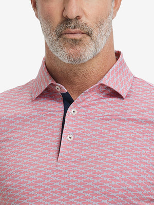 Close-up from nose to chest, showing collar and fabric pattern detail of the pink small fish polo shirt.