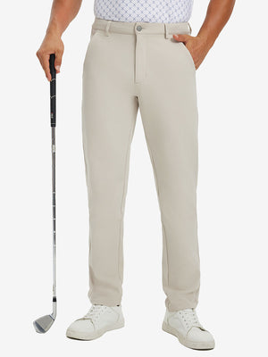 Lightweight moisture wicking dress pants in light khaki, front lower-body with model leaning on golf club.