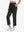 Front lower-body view of model with right hand in pocket wearing BLACK Women's 7/8 Ankle Golf Track Pants.