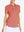 Front view from nose to hem of model wearing CORAL PINK Women's Performance Solid Polo with skirt