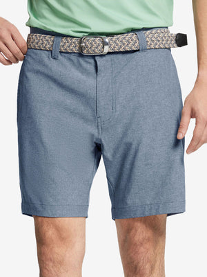 Front view of youth wearing dark blue Heather Performance Golf Shorts, showing fit and style