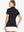 Back-side half-body shot of model in BLACK Women's Performance Solid Polo, looking over shoulder