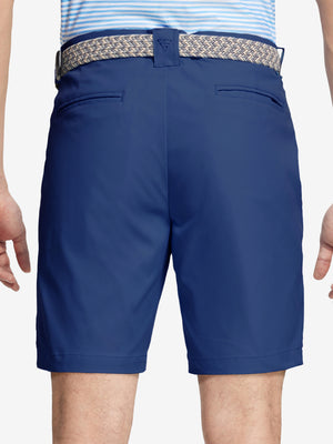 Back waist to knee view of cobalt water resistant golf 9 inch shorts, flexible performance fit.