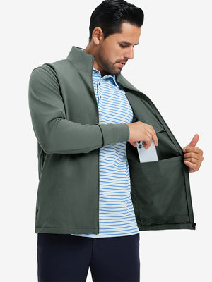 Model wearing water-resistant zip up golf jacket, slate green, front upper-body with one hand in pocket.
