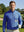 Upper body close-up of model holding golf club in full print lightweight quarter zip pullover, cobalt wave