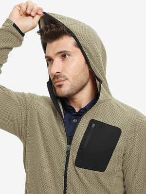 Model wearing hood and pulling it slightly, dressed in full zip fleece hoodied jacket in desert yellow.