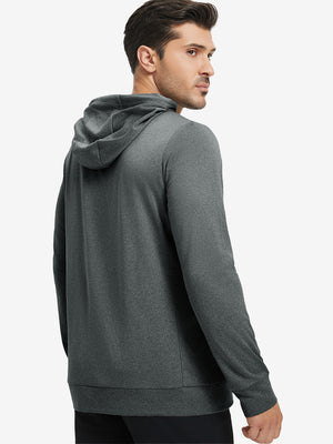 Back upper body view of the black melange classic heather hoodie, model turns head slightly with ease.