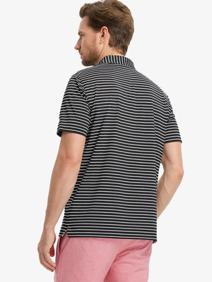 Back half-body shot of model wearing BLACK/WHITE STRIPE Polo, tailored fit