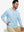 Model sitting with one hand in pocket wearing casual solid fleece hoodies pullover in light blue.