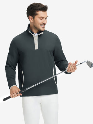 Model holding golf club, wearing mock neck quarter button golf pullover in dark grey, sporty look.
