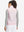 Back view of model in women's lightweight slim-fit puffer vest, showing shape and light pink tone