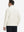 Back upper body view of the cream lightweight golf pullover, model turns head slightly with ease.