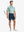 NAVY 4-way Stretch Performance Solid Shorts, golfer full-body front with club, 7 Inch length