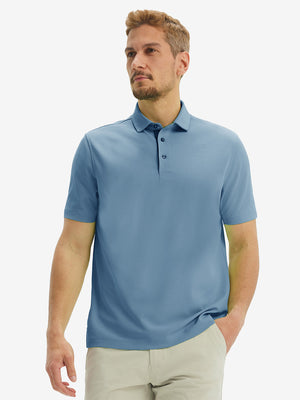 Front half-body shot of model wearing the misty blue ventilated pique performance polo for a casual sporty look