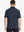 Back view half-body of model in DARK GREY Ventilated Pique Performance Polo