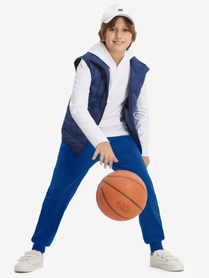 Full-body shot of model wearing klein blue fleece stretch water resistant boys joggers while playing basketball.