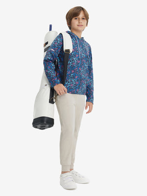 Model holding a golf bag, wearing navy colorful flower youth full print stylish hoodies pullover in full-body view.