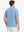 Rear half-body view of Everyday Solid Jersey Polo in LIGHT BLUE, showcasing neat back fit.