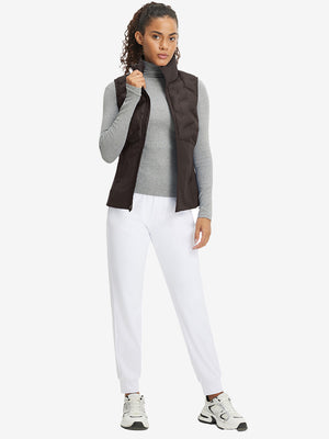 Model holding golf club full body, women's lightweight slim-fit puffer vest styled in sporty coffee brown