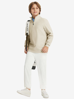 Full body model carrying a golf bag, wearing youth winter micro-fleece quarter zip pullover in light khaki