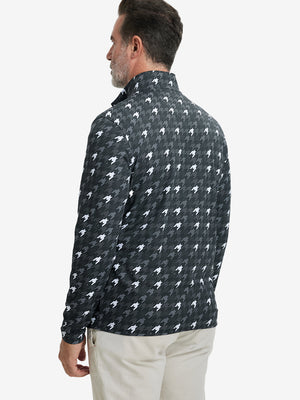 Back upper body angle of the grey houndstooth full print quarter zip pullover, model turns head slightly.
