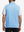 Back upper body shot of model wearing light blue melange lightweight sleeveless quarter zip golf vest