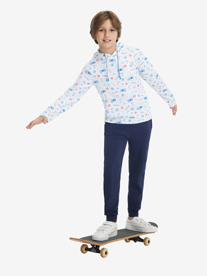 A full-body shot of a model wearing a youth full print stylish hoodie pullover in whitecartoon toy color, confidently riding a skateboard.
