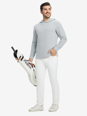Model holding a golf bag, wearing light grey heather texture solid hoodies pullover in full-body view.