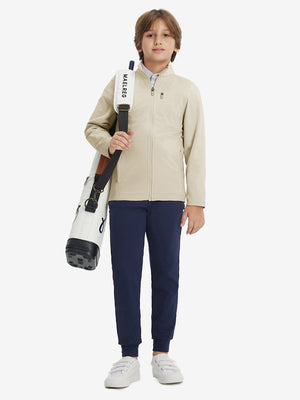 Full-body view of model wearing kids soft lightweight fleece lined jacket in light khaki, displaying the jacket's fit and design.