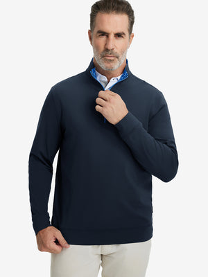 Front upper body view of model wearing lightweight golf quarter zip pullover in navy, relaxed fit.