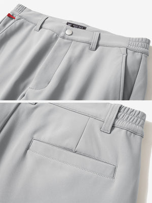 Close-up of the waistband details on light grey water-resistant stretch heat-tech winter trousers