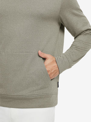 Close-up of model with both hands in pockets wearing warm fleece golf hoodies pullover  dust beige.