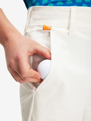 Detail: pocket of white boys lightweight dry fit flat front golf shorts