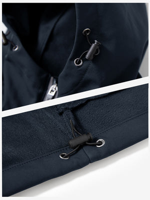 Close-up of zipper and button details on reflective hooded softshell jacket in navy.