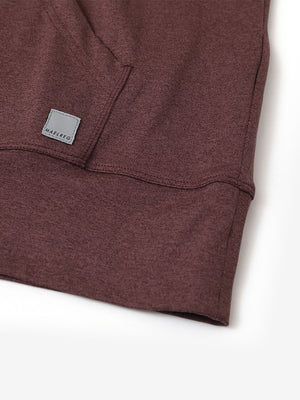 Hemline detail of the Quarter Zip Hoodie in Brick Heather, showing neat edges and fine craftsmanship.