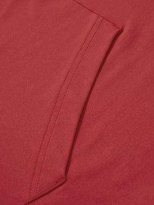 Close-up of single pocket detail on youth long sleeve hoodied with kangaroo pocket in red, showing stitching.