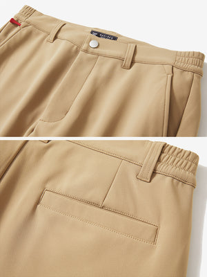 Close-up of the waistband details on khaki water-resistant stretch heat-tech winter trousers
