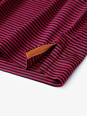 Hem slit detail of RED STRIPE polo shirt, functional cut in a bold golf-ready design