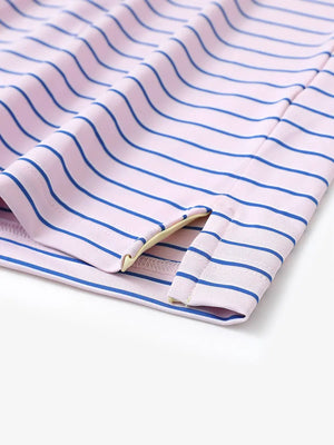 Hem slit detail of LIGHT PINK/COBALT STRIPE Youth Performance Golf Polo highlighting stitching and finish.