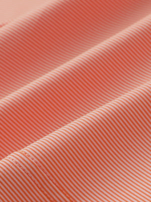 Fabric close-up of Pinstripe jersey performance polo with fine stripe texture in orange stripe