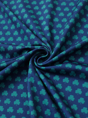 Close-up of four leaf clover performance jersey print polo fabric showing breathable texture.
