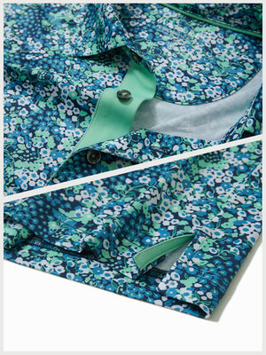Hem detail of Performance quick dry print golf polos with neat stitching and navy green floral finish