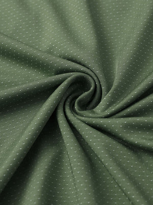 Close-up of dark green 4 way stretch jacquard polo fabric texture highlighting intricate woven pattern and elasticity.