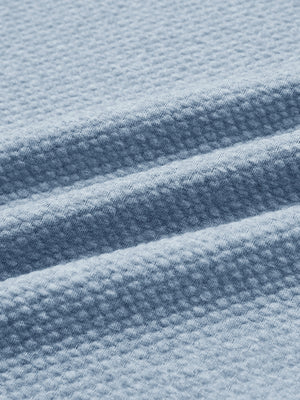 Close-up of fabric on texture solid hoodies pullover, showing texture and finish in blue heather